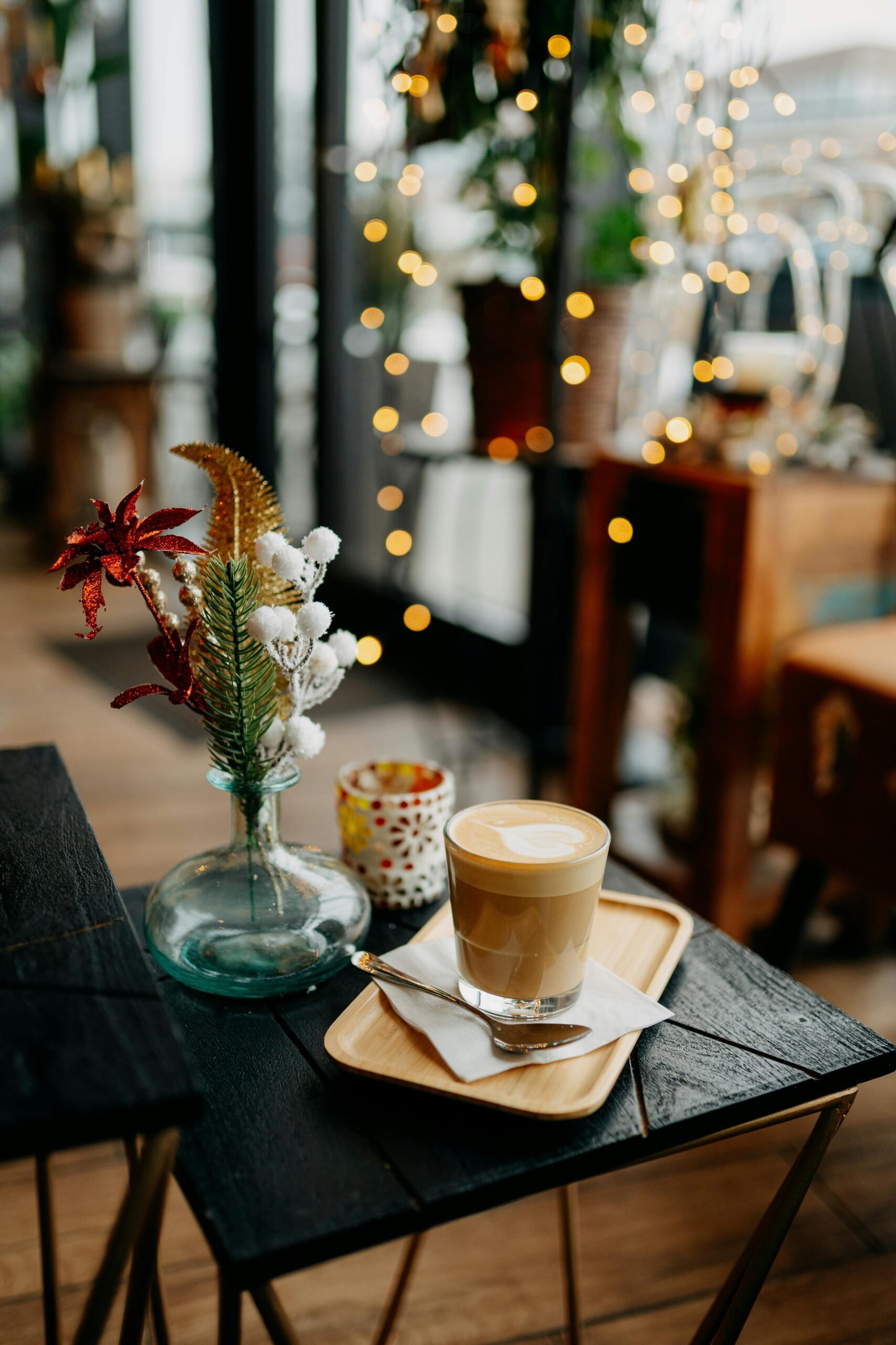 Photo of a Glass of Coffee on a Wooden Table in a Cafe